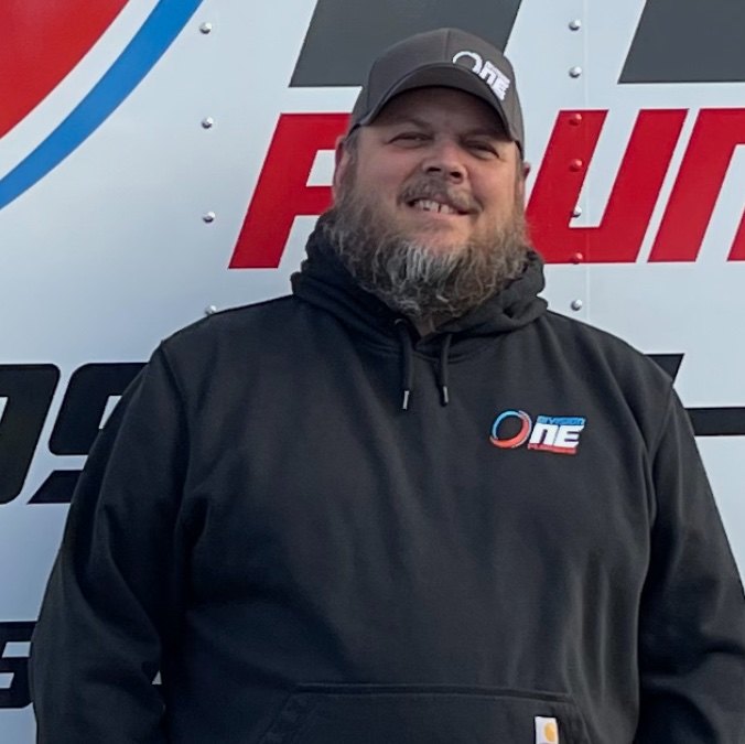 Dave Harrison, owner of Division One Plumbing, standing in front of a company truck