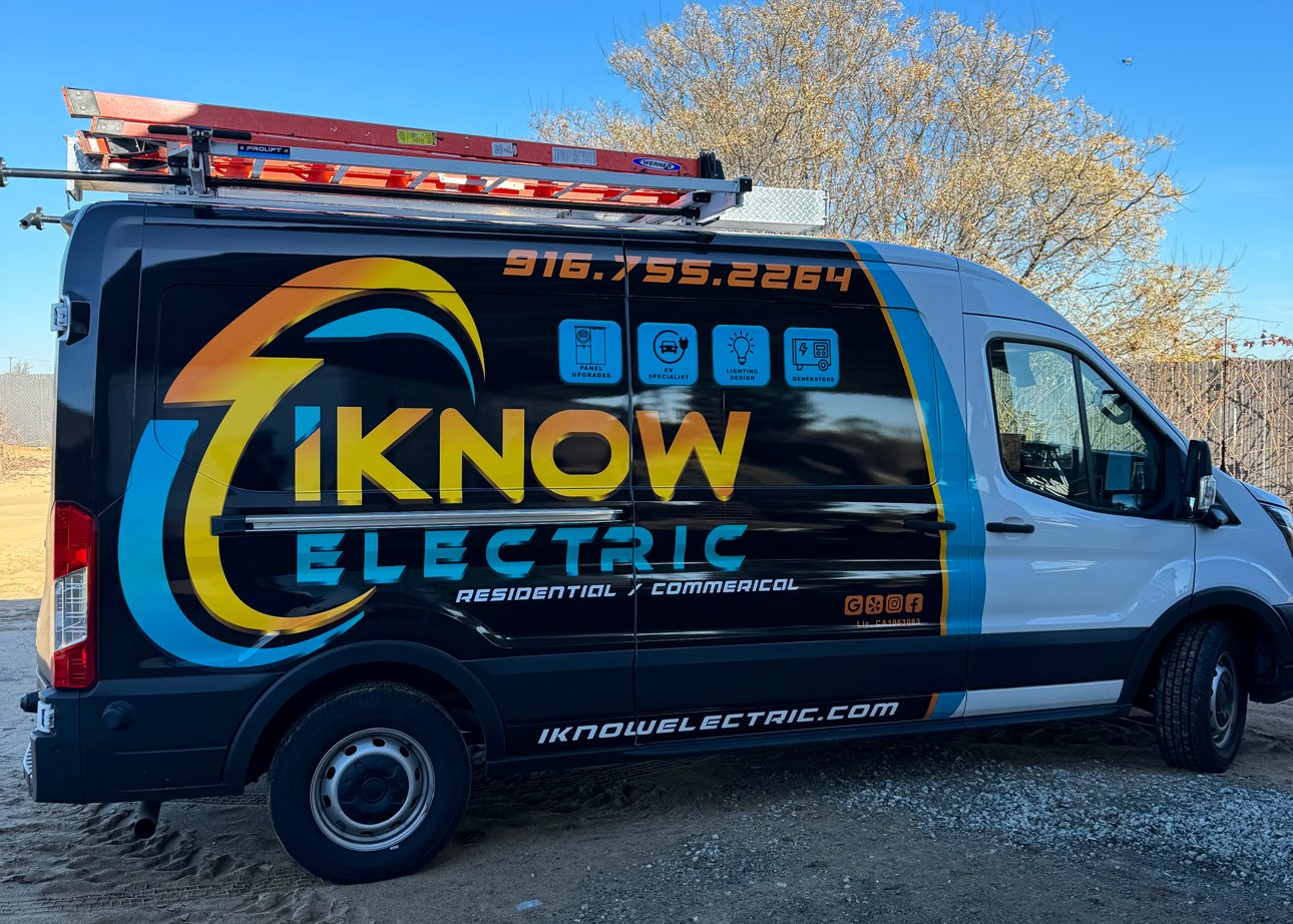 iKnow Electric work van with ladder rack, showing the company logo, phone number and residential and commercial lettering