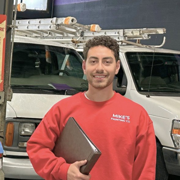 Micah Zimmerman, founder of Mike's Painting Co., in branded shirt