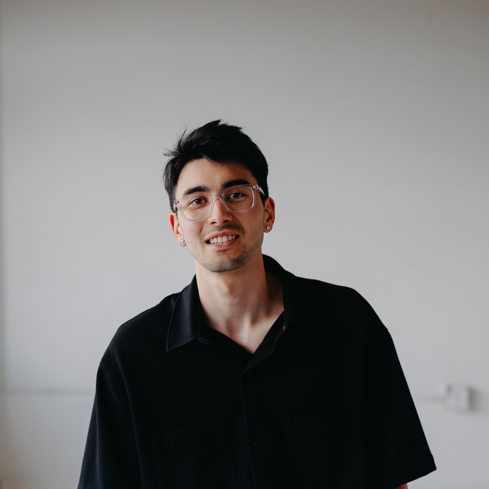 Vlad, owner of Seattle Commercial Cleaning Co., smiling while seated in a bright studio